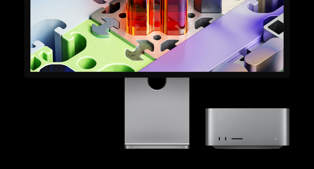 Mac Studio associé à un Studio Display XDR, le Mac est placé sous l’écran : le Studio Display XDR affiche un fond d’écran tridimensionnel de type puzzle